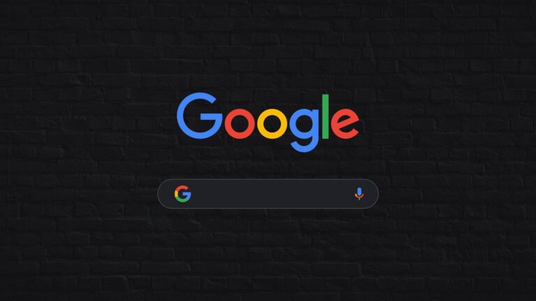 Google logo above a dark-themed search bar with a microphone icon, set against a black brick wall background.