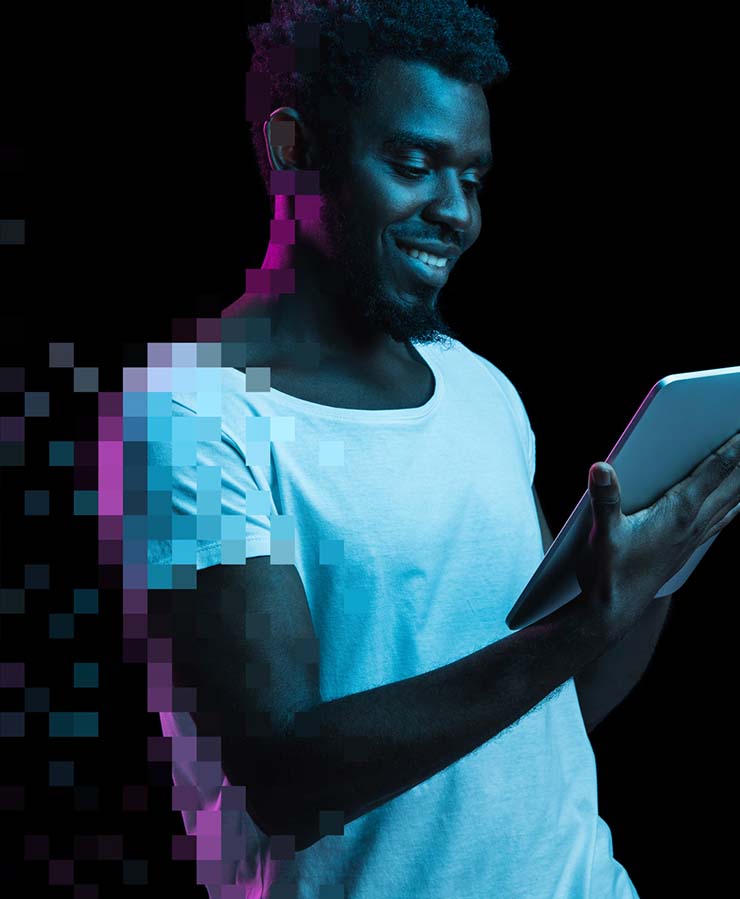 A man in a white shirt holds and uses a tablet, with digital pixelation effects on his left side against a black background.